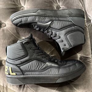 CHANEL Black High-Top Sneakers with Gold CC Accent